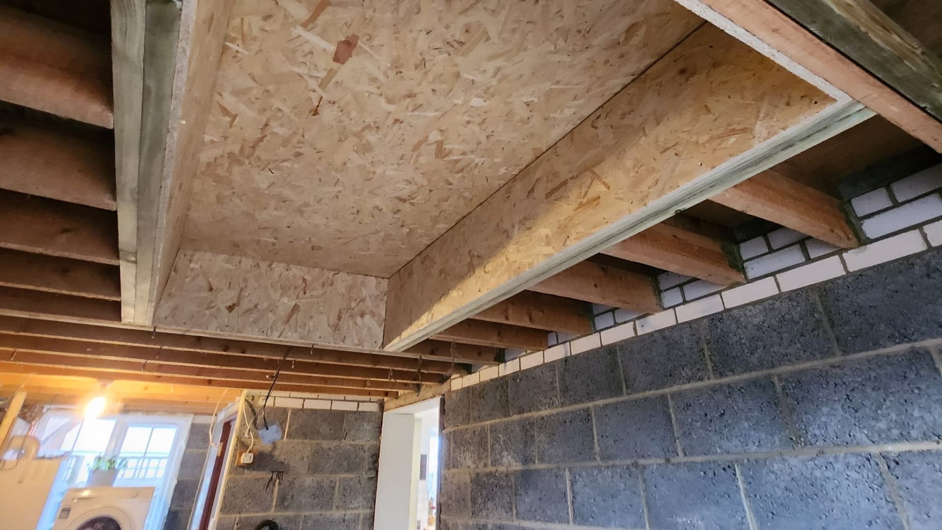 New floor joists and decking installed during an extension build